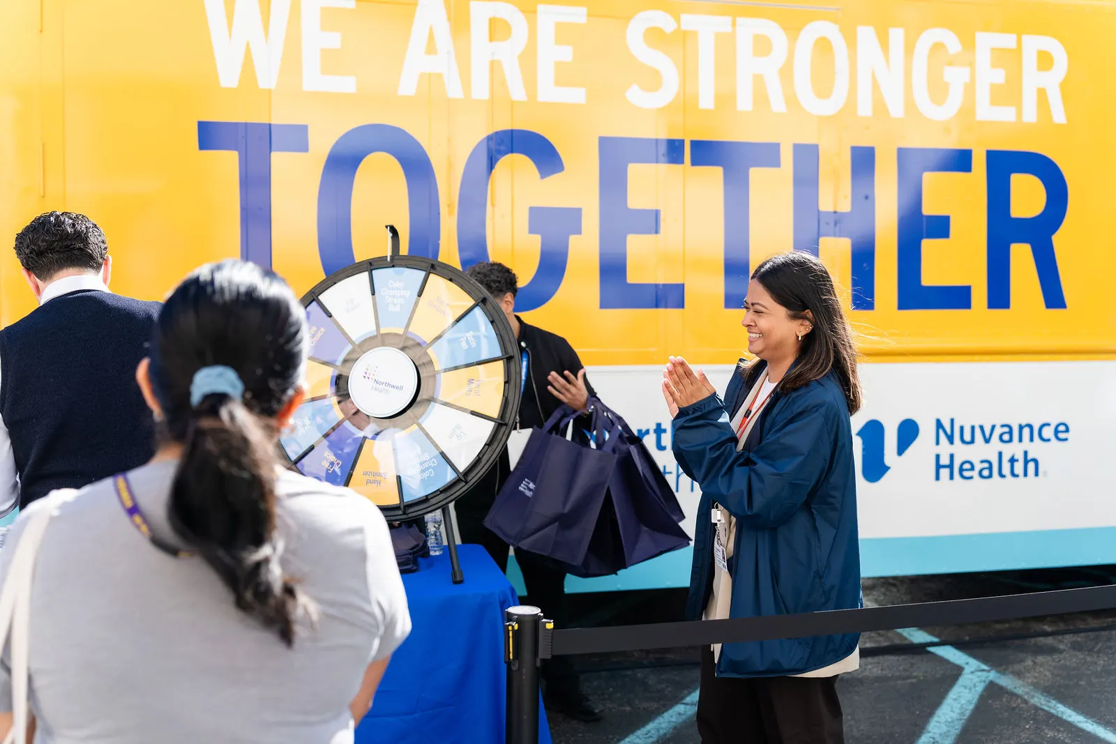 Team member spinning the prize wheel in front of the branded truck at Putnam Hospital