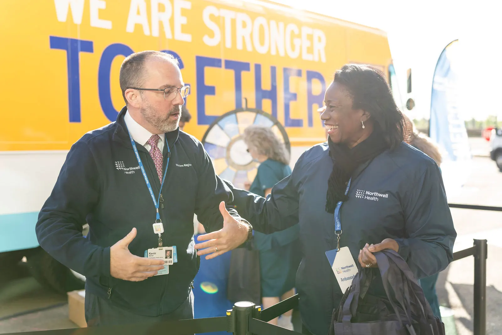 Northwell leader chatting with a team member beside the branded truck at Norwalk Hospital