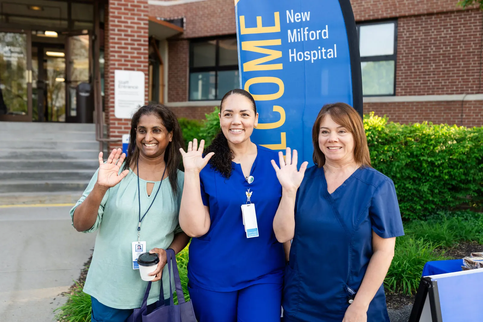 New Milford Hospital nurses waving by the Welcome banner