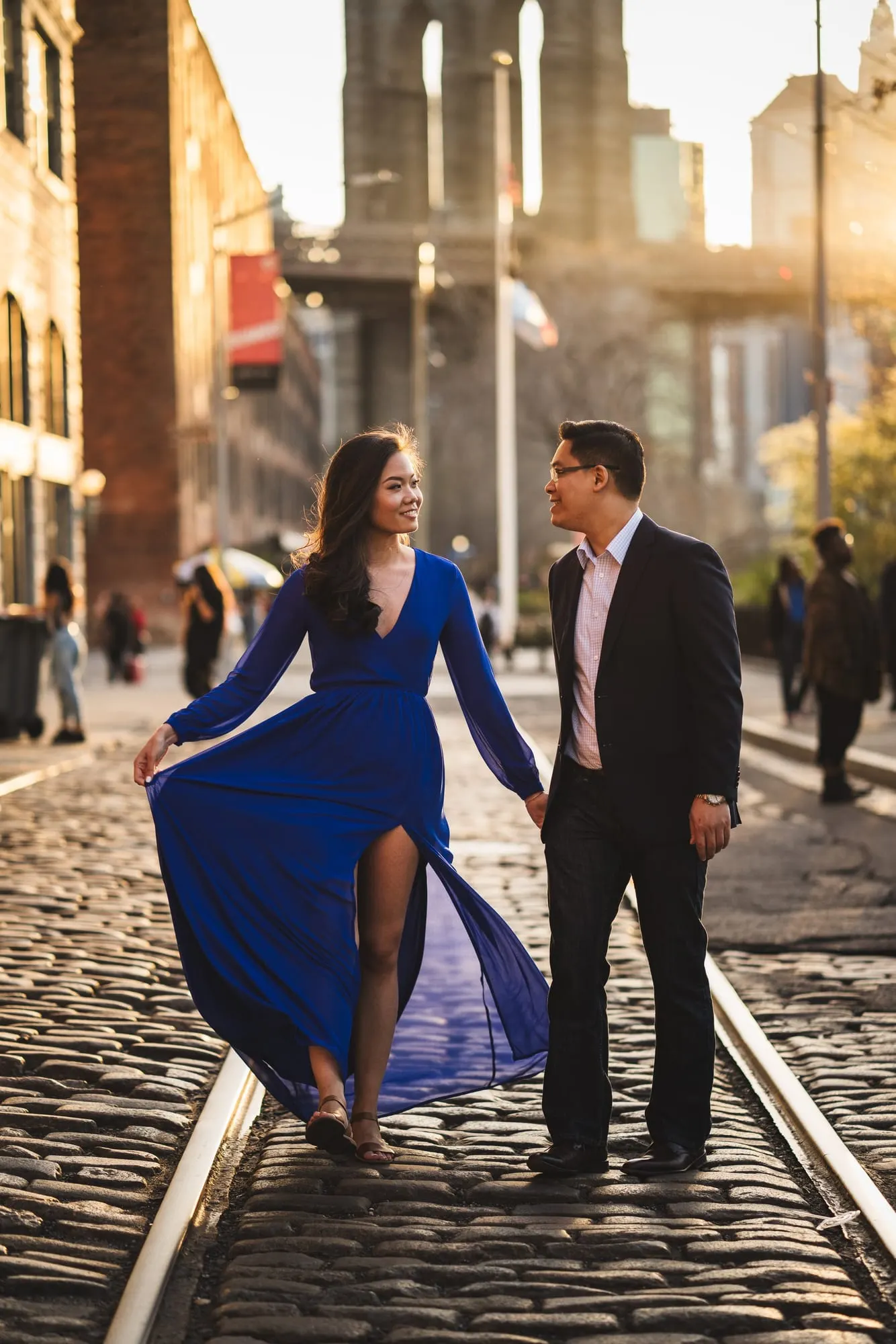 Couple walking along the cobblestone streets of DUMBO, Brooklyn during their engagement session