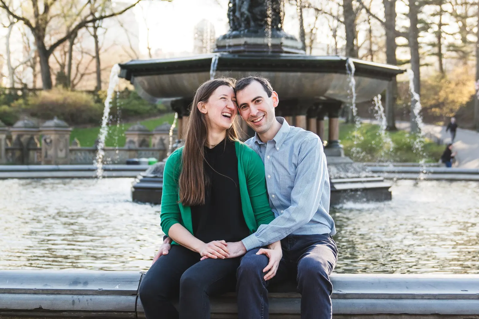 Couple laughing together at Bethesda Fountain in Central Park during their NYC engagement session