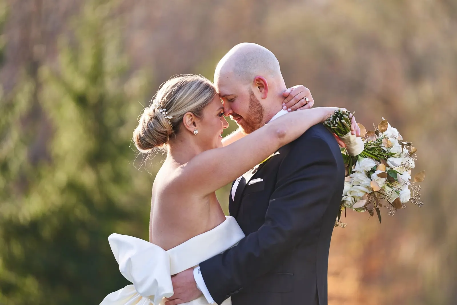 Bride and groom embracing at golden hour on the lawn at Doral Arrowwood in Westchester
