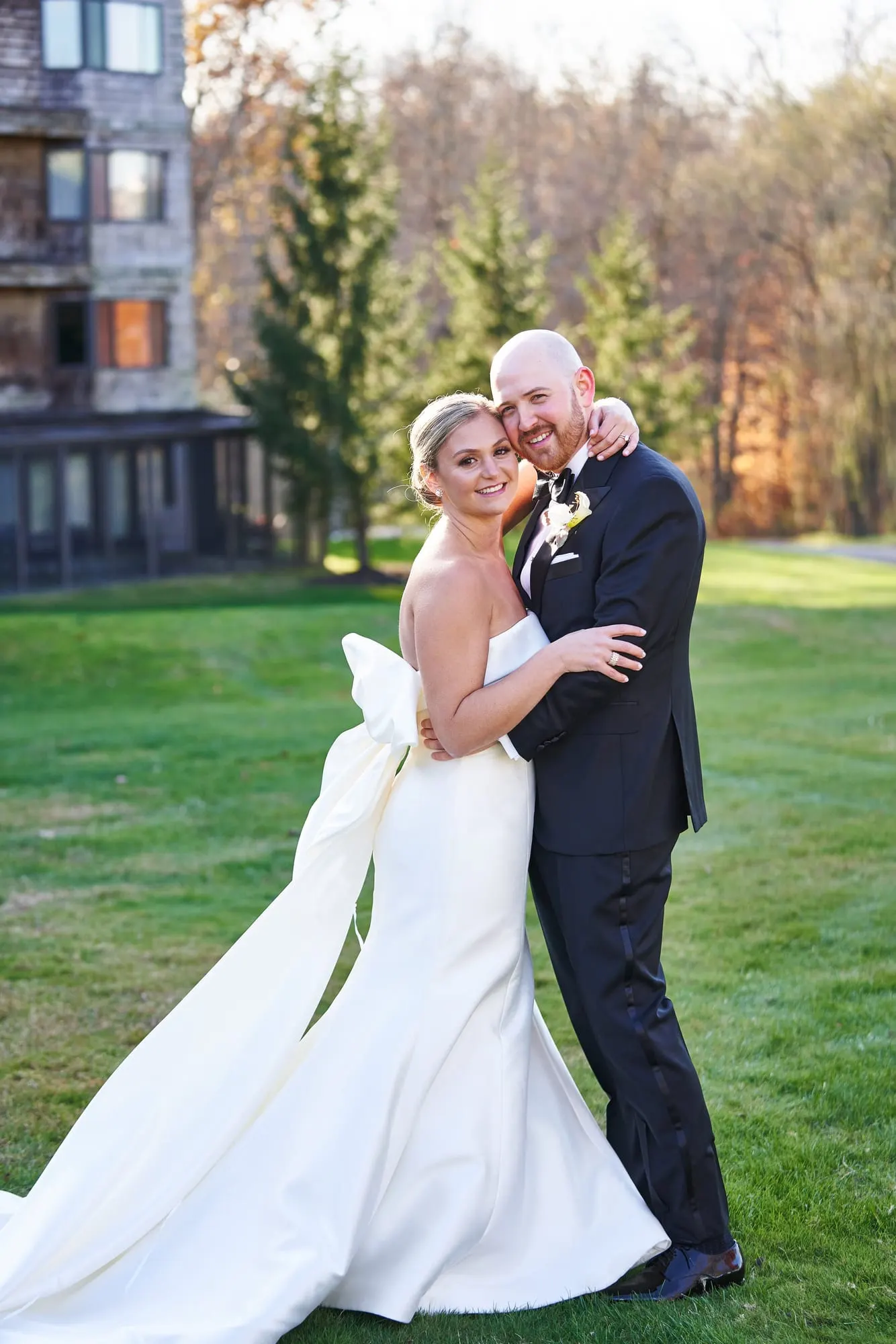 Bride and groom embracing on the lawn