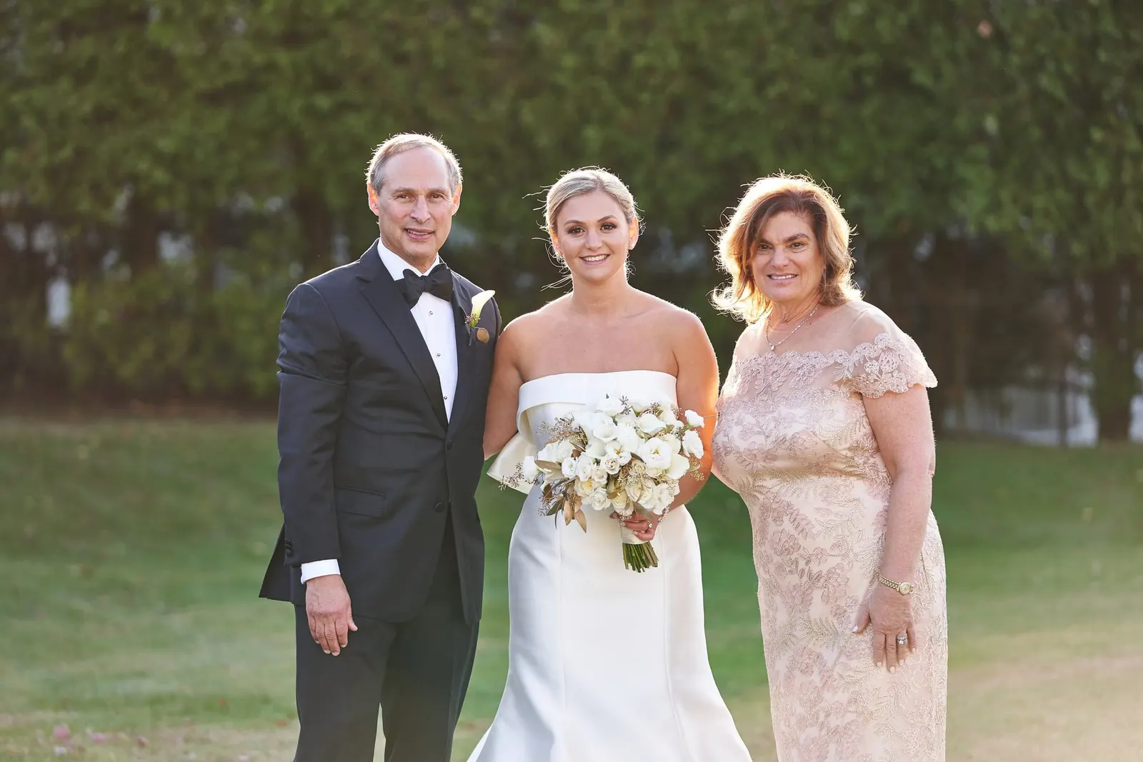 Bride with her family on the lawn before the ceremony
