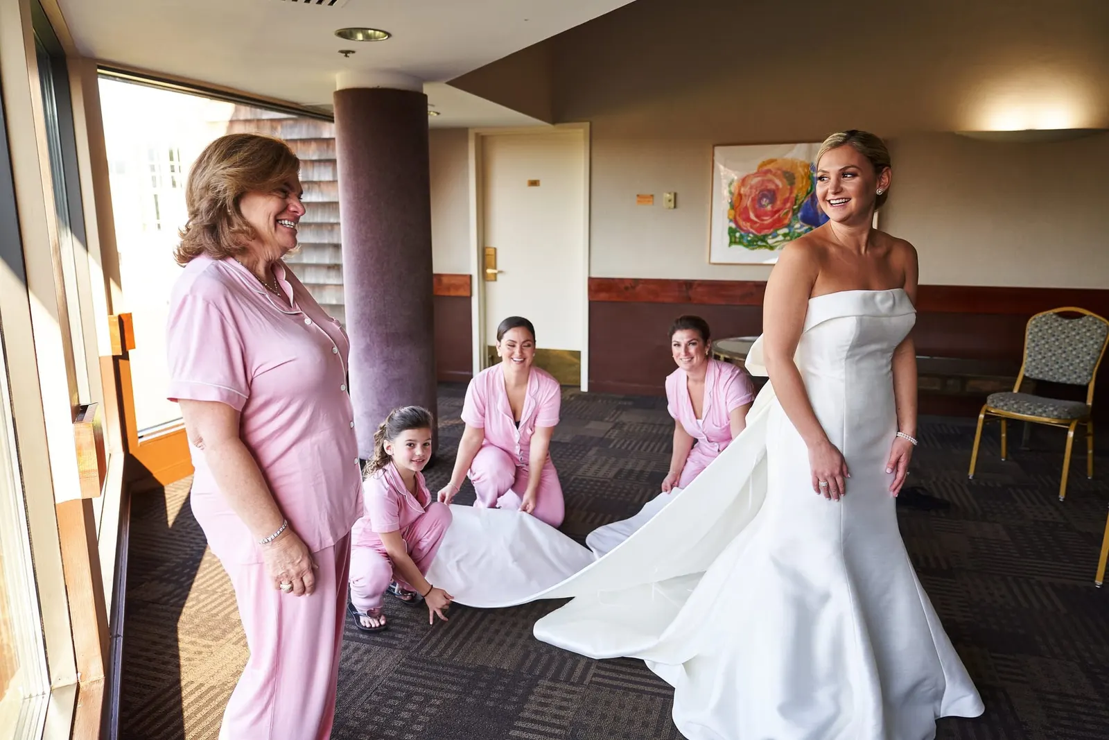 Bride getting ready with her bridesmaids and flower girls in blush pink