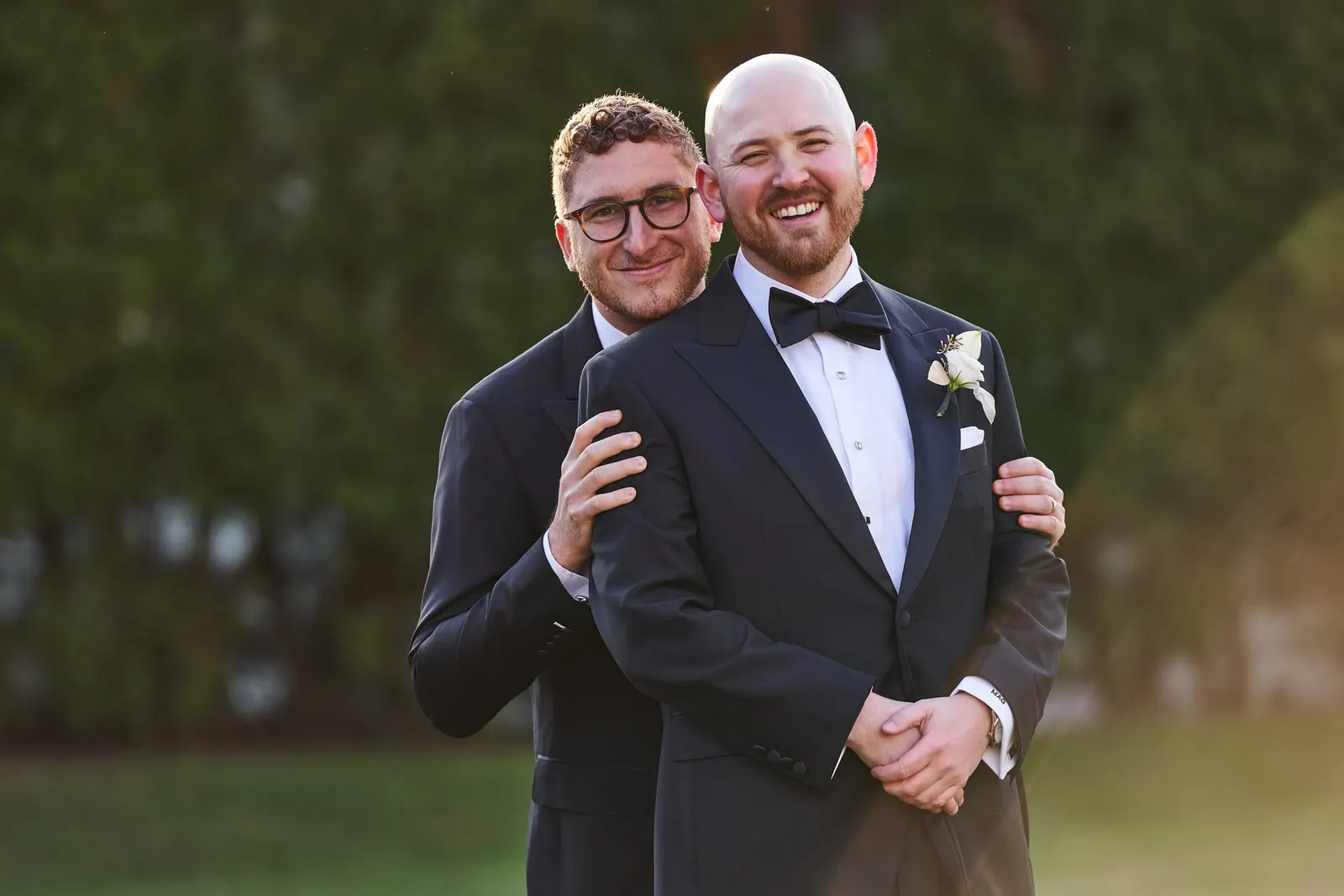 Groom sharing a hug with a groomsman