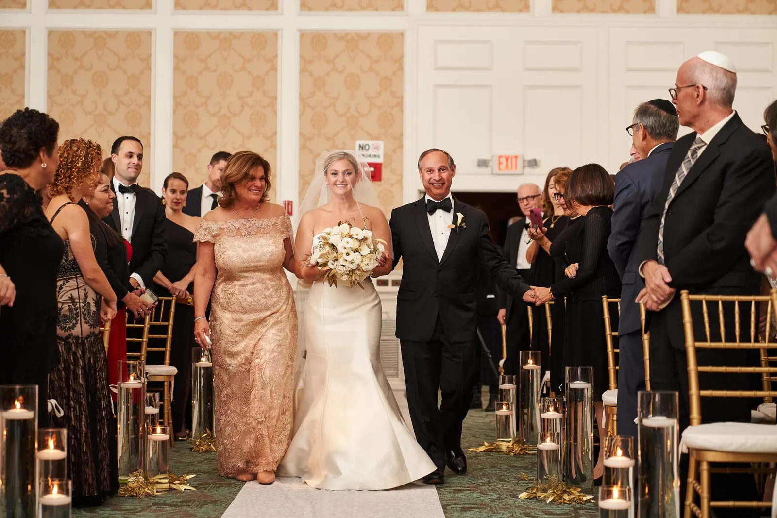 Bride walking down the aisle with her parents