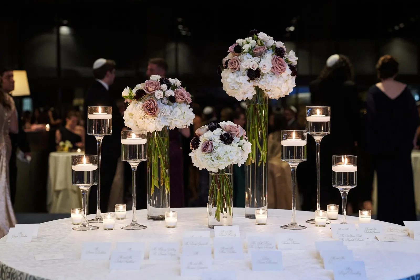 Escort card table with white and blush floral centerpieces