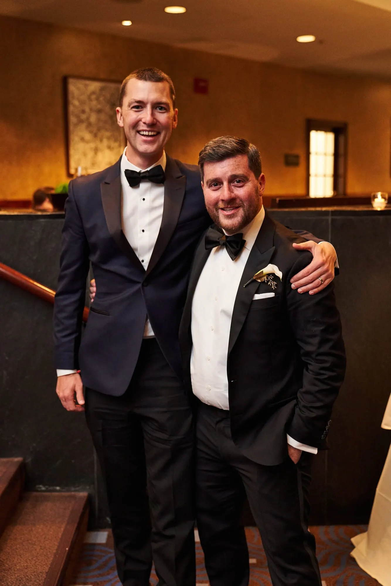 Groom with a friend during cocktail hour