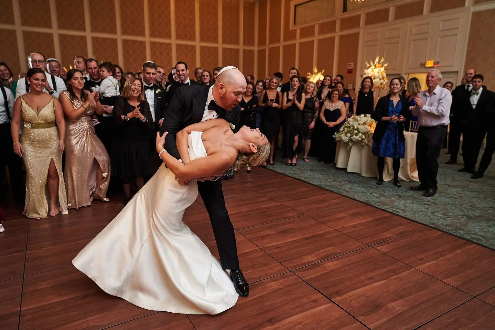 Groom dipping the bride at the end of their first dance