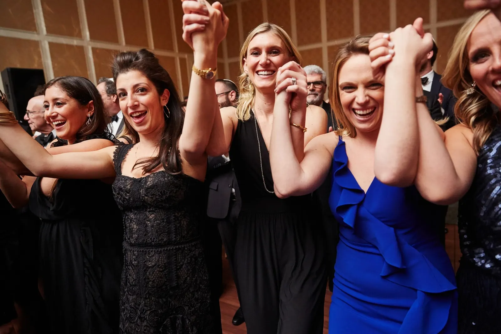 Friends dancing and cheering on the dance floor