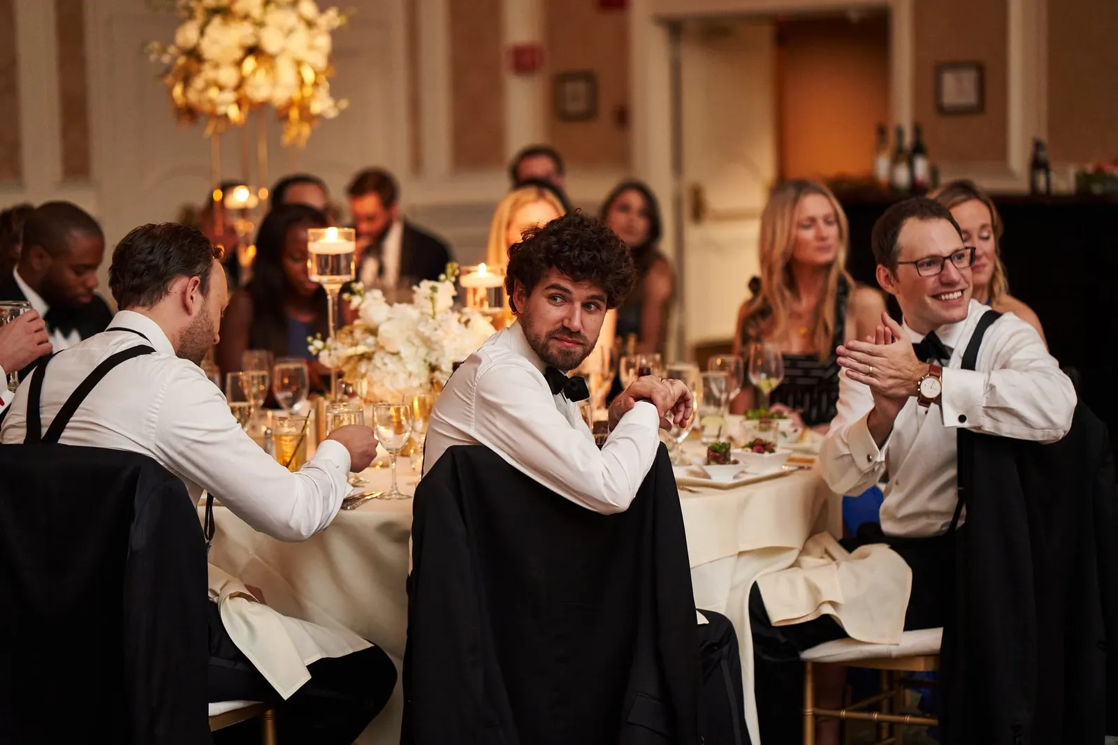Guests laughing at their tables during the reception