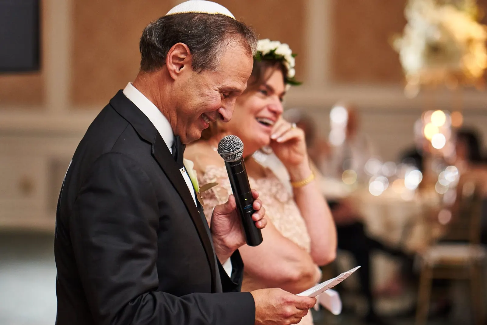 Guests laughing during a toast
