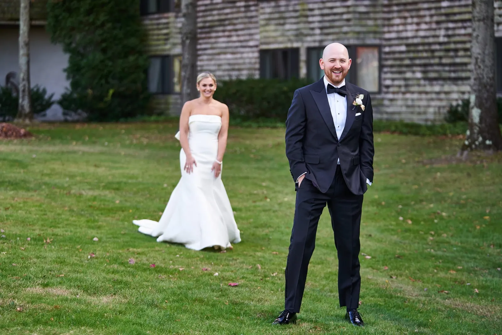 Bride and groom on the lawn in front of the resort